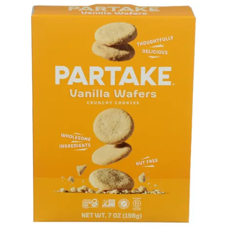 A bright orange box of Partake Vanilla Wafers features the product name prominently, with images of stacked cookies and text highlighting that they are nut-free and made with wholesome ingredients.