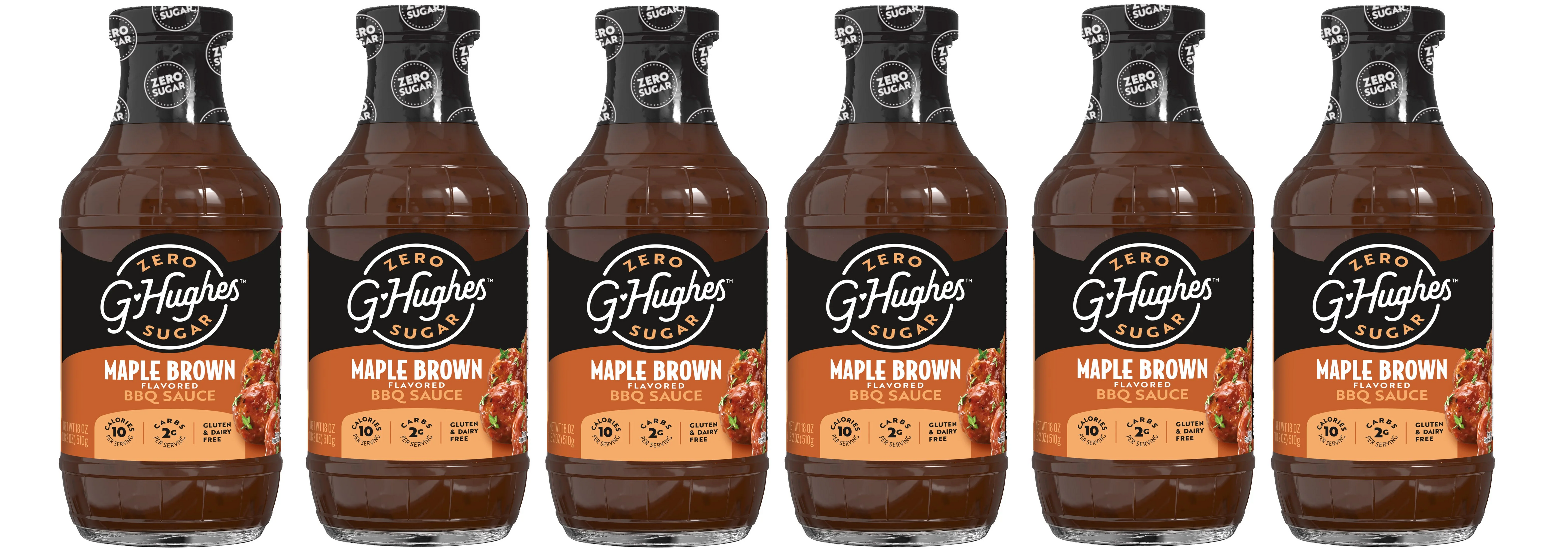 Five bottles of G. Hughes Maple Brown BBQ Sauce are lined up, showcasing their dark brown liquid and labels highlighting "Zero Sugar," "Gluten & Dairy Free," and nutritional information.