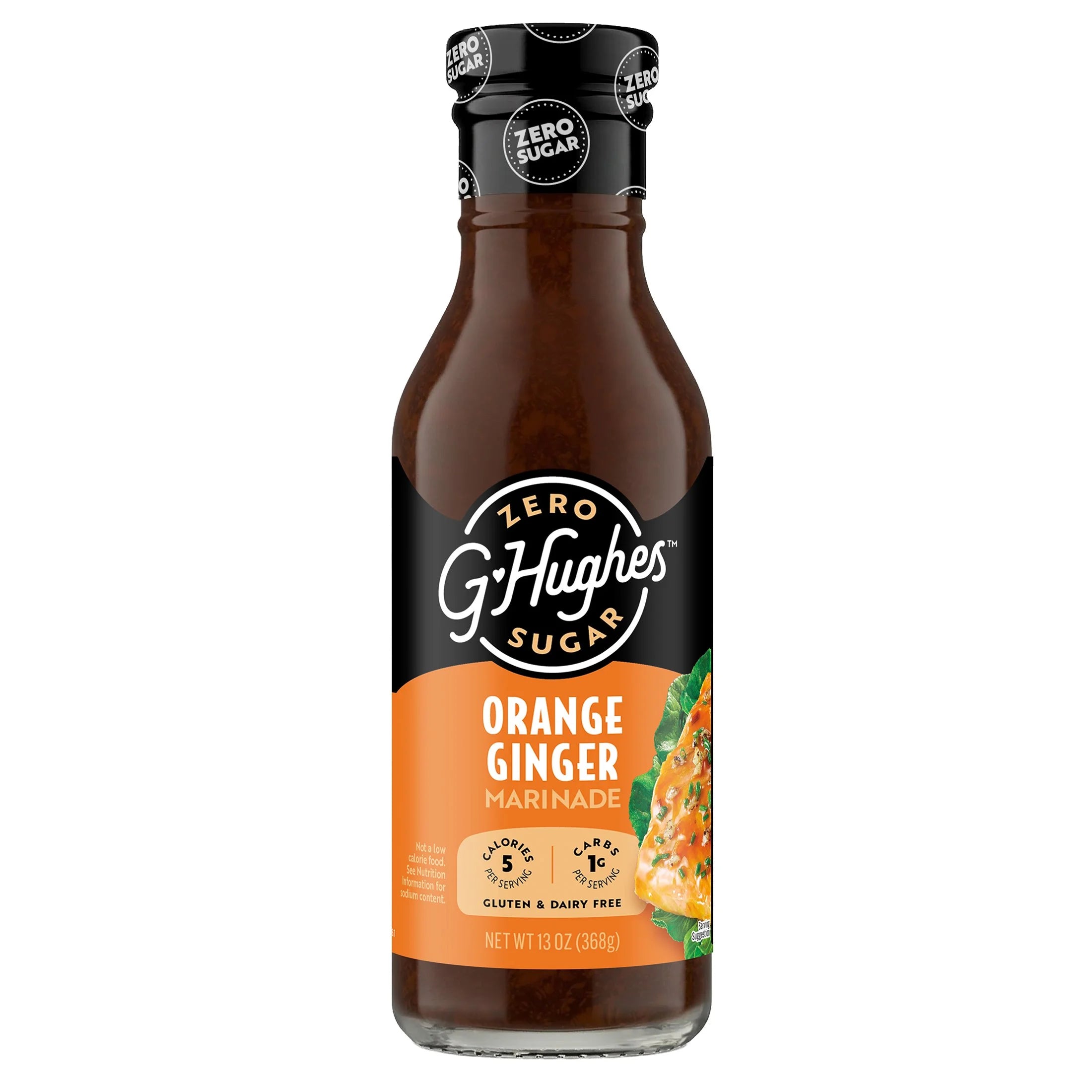 A glass bottle of G. Hughes Zero Sugar Orange Ginger Marinade, featuring a black and orange label, showcasing the product name and nutritional information, with a 13 oz capacity.