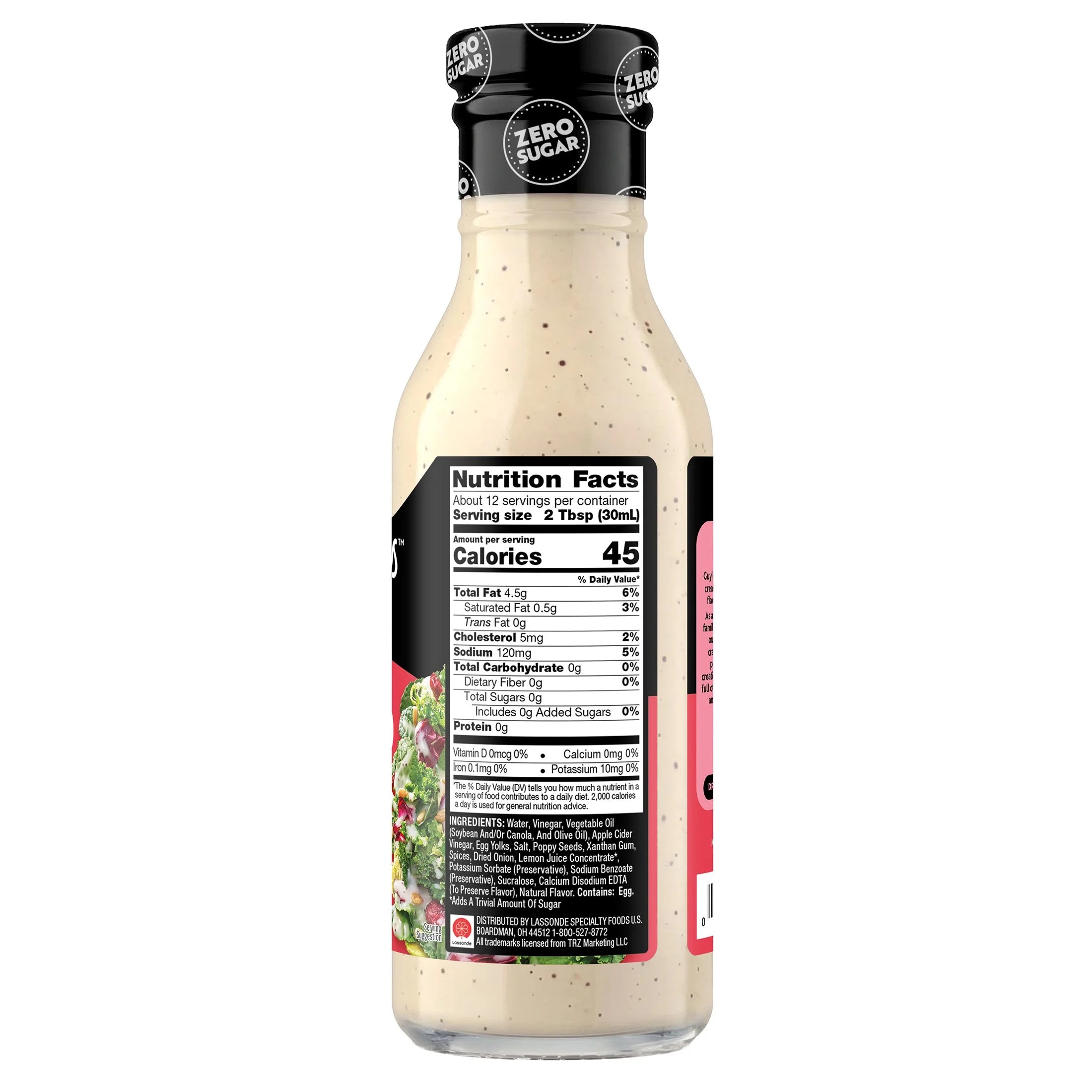A clear glass bottle of salad dressing displays the nutrition facts label, highlighting "zero sugar," with a creamy dressing inside and a colorful salad image on the label.