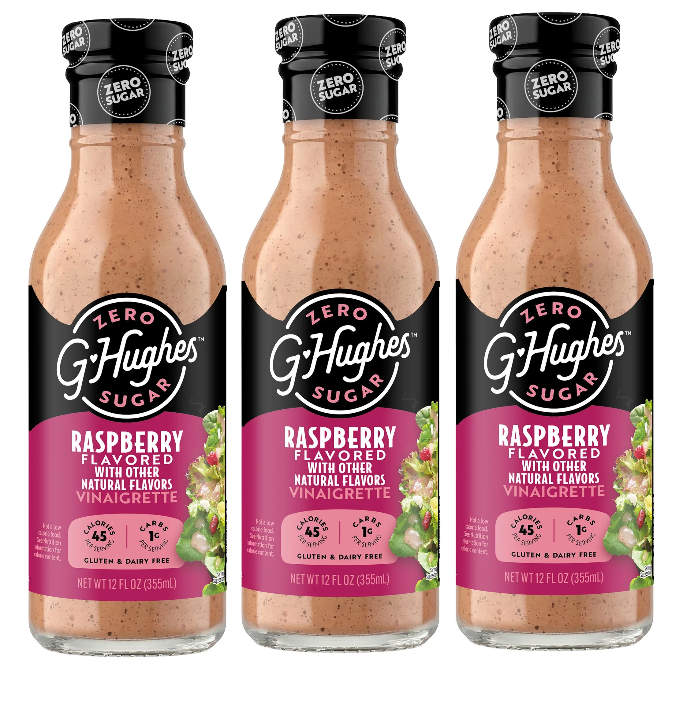 Three bottles of G. Hughes Zero Sugar Raspberry Vinaigrette are displayed, each labeled with nutritional information, highlighting its gluten-free and dairy-free qualities.