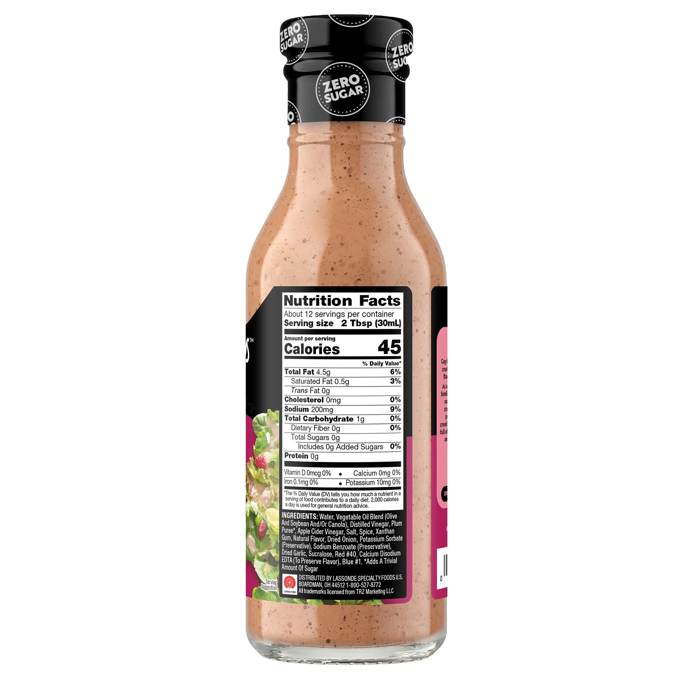 A clear bottle of salad dressing features a creamy, light brown liquid and a black cap, with a nutrition facts label prominently displayed on one side.