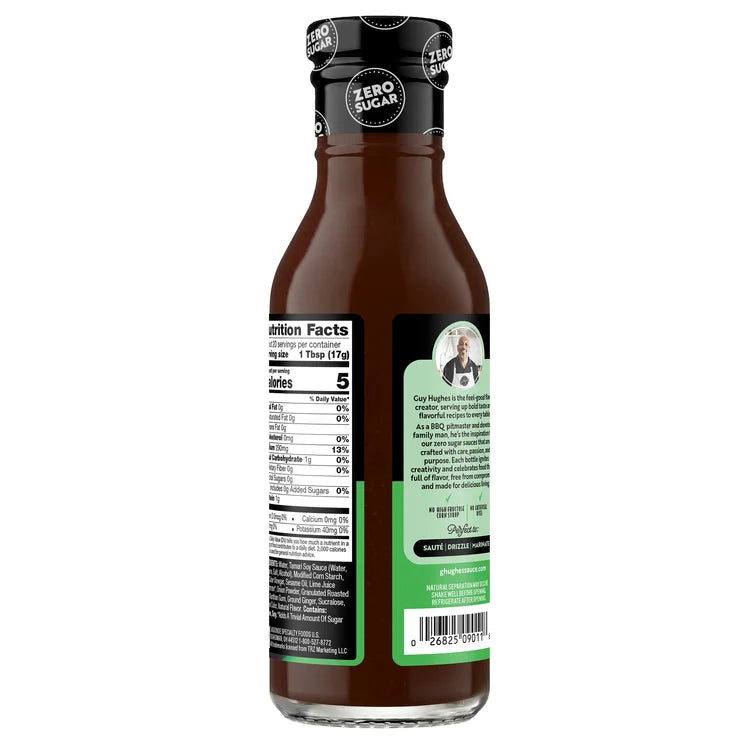A bottle of zero sugar BBQ sauce features a black cap and a label with nutrition facts and a description of the creator, Guy Hughes, emphasizing its flavorful, low-calorie ingredients.